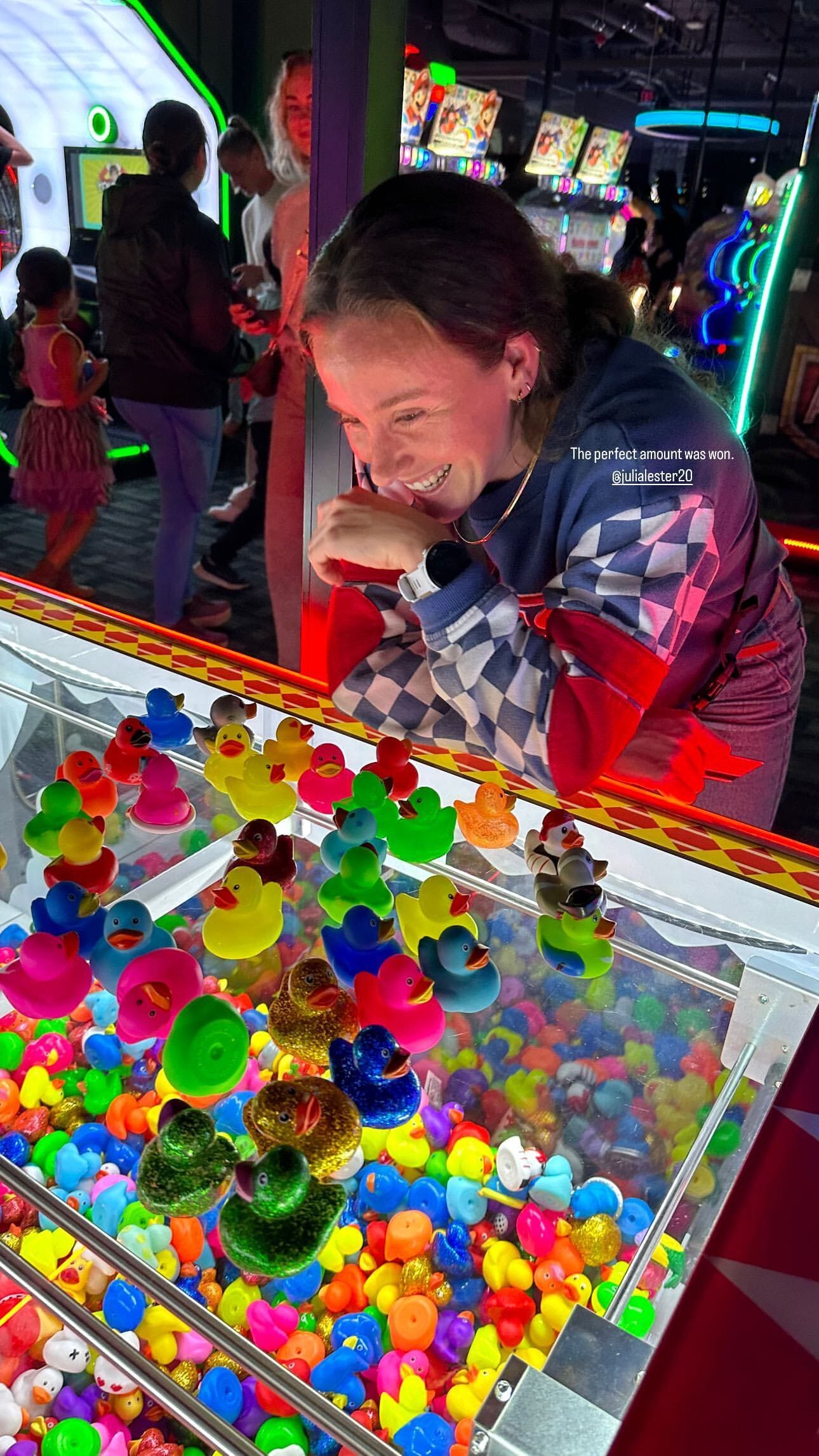 Seattle Reign FC defender Julia Lester stands over a bunch of rubber ducks.